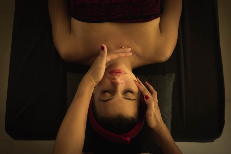 A woman enjoying a relaxing facial massage at a spa.